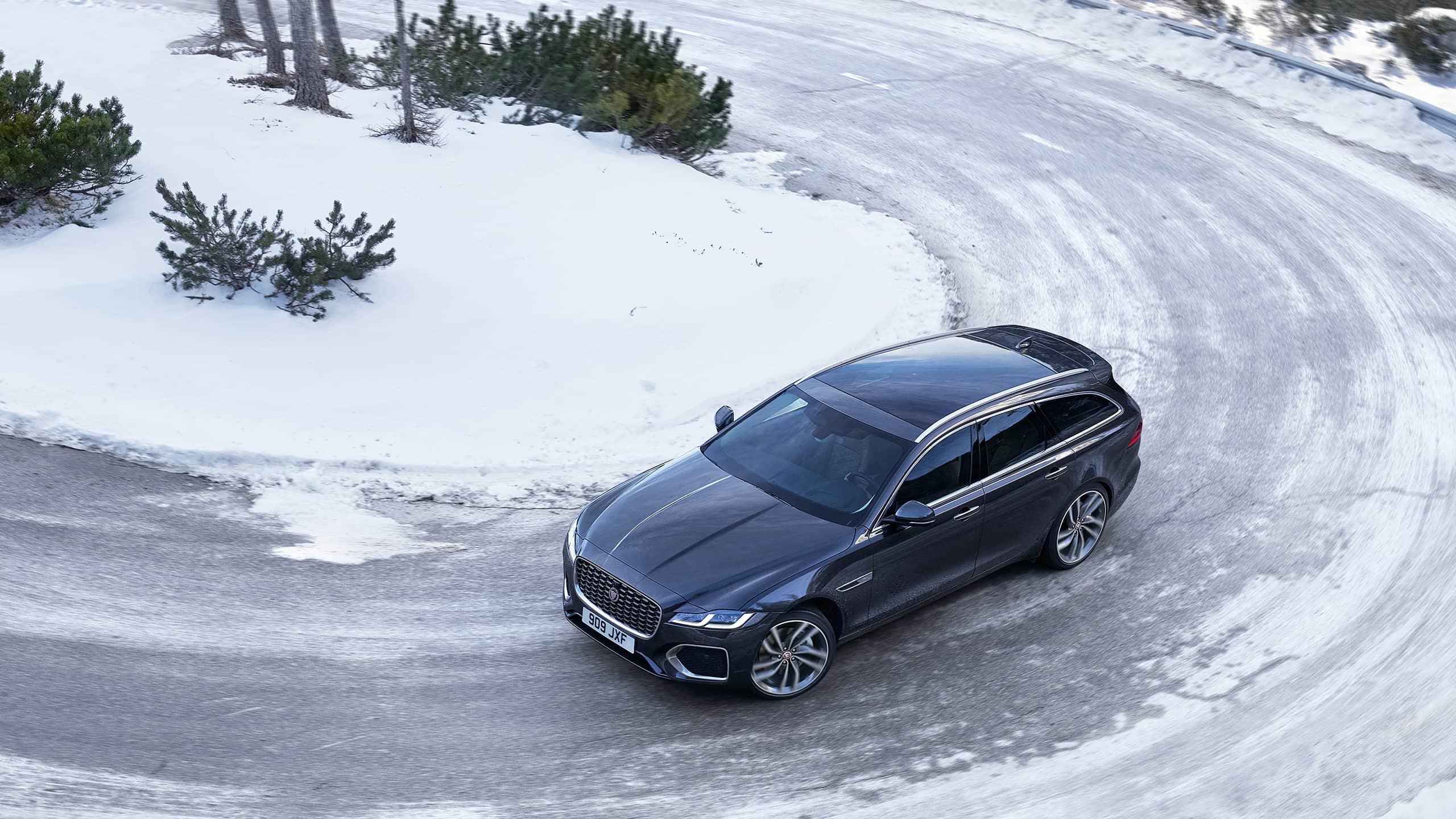 Parked Jaguar XF running on ice road